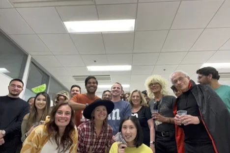 Kristina Bergersen and group of Reed Lab members smiling to celebrate award.